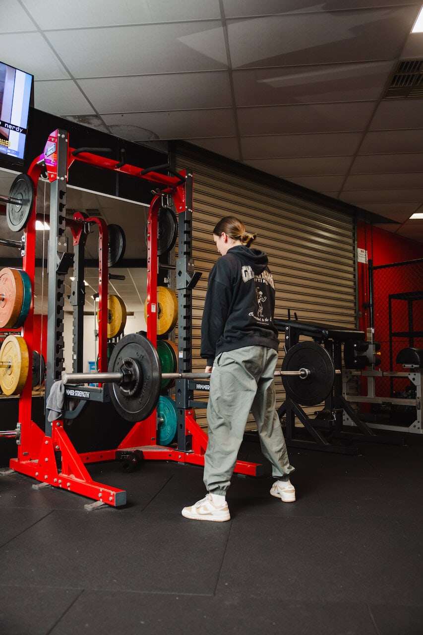 Girl doing deadlift in rack
